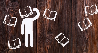 Paper man with book for head