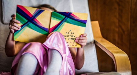 Girl reading physics