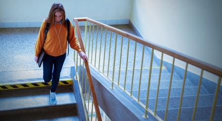 Teenage girl walking down stairs