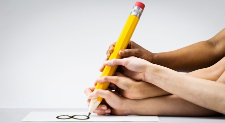 Hands writing notes with big pencil