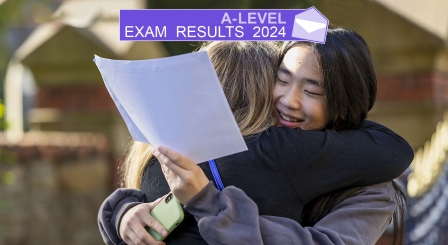 Two students receiving A-level exam results at school