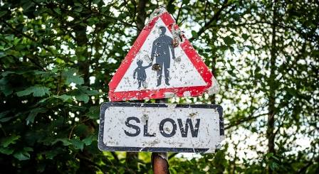 Slow down road sign