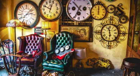 Chairs in room filled with clocks