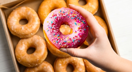 Hand picking fancy doughnut