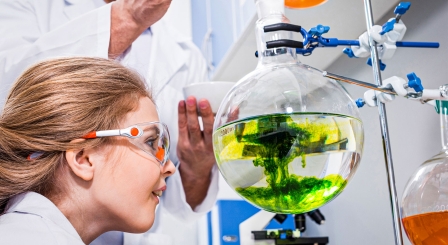 Teacher showing pupil a chemistry experiment