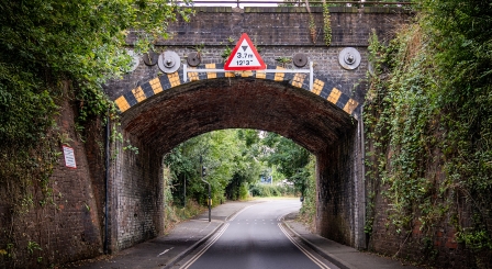 A bridge underpass with a height restriction