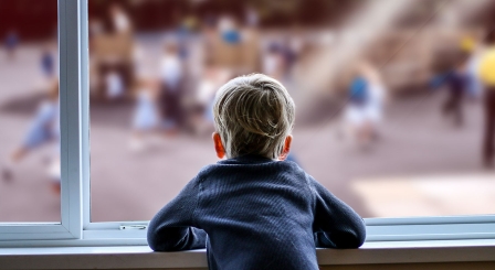 Child looking out of window at playground