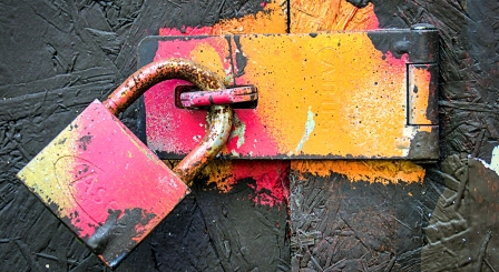 A padlock painted green orange and pink