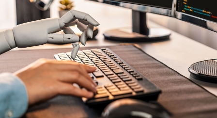 Human and robot hands using keyboard