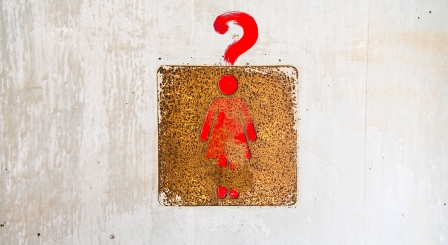 A female sign with a question mark over it