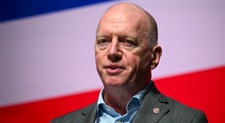 Matt Wrack in front on red, white and blue background