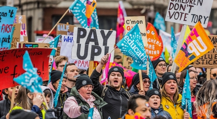 NEU members on strike holding placards