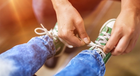 Parent tying shoe laces