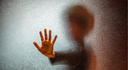 Image of child behind frosted glass