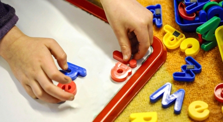Spelling ia on a child's magnetic board