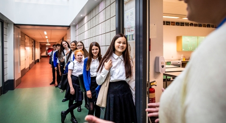 Pupils queuing outside classroom