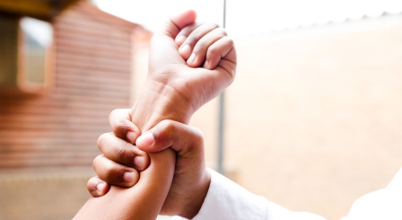 Teacher gripping student's arm