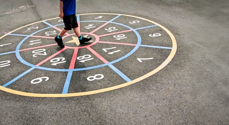 Pupil walking around numbers in playground