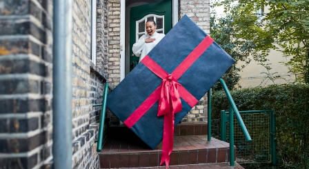 high expectations, behaviour, woman receiving huge parcel