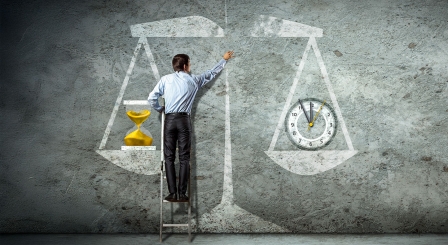 Man with drawing of scales weighing time