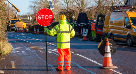 Man holding STOP sign
