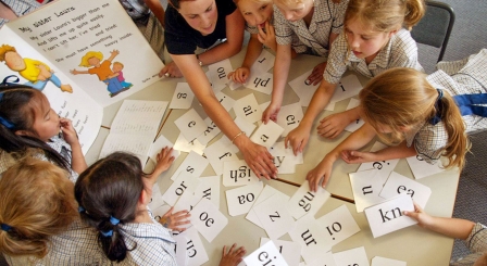 Children with phonics cards