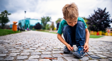 Boy tying shoe laces