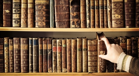 Hand reaching for old book