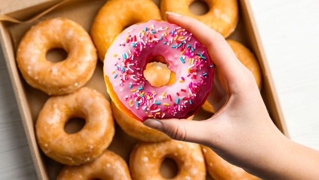 Hand picking fancy doughnut