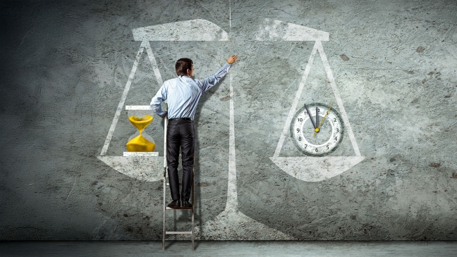 Man with drawing of scales weighing time