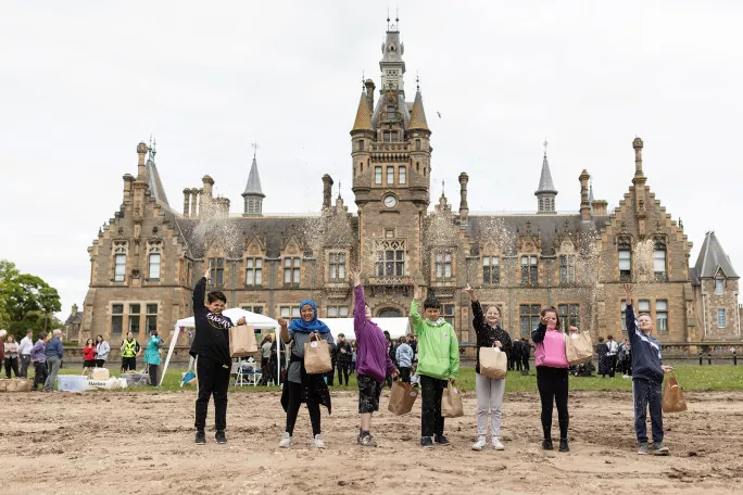 Morgan Academy pupils sowing the school's wildflower meadow in May 2022