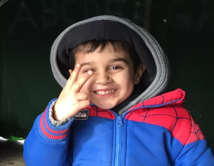 pic of spiderman refugee boy in calais jungle camp