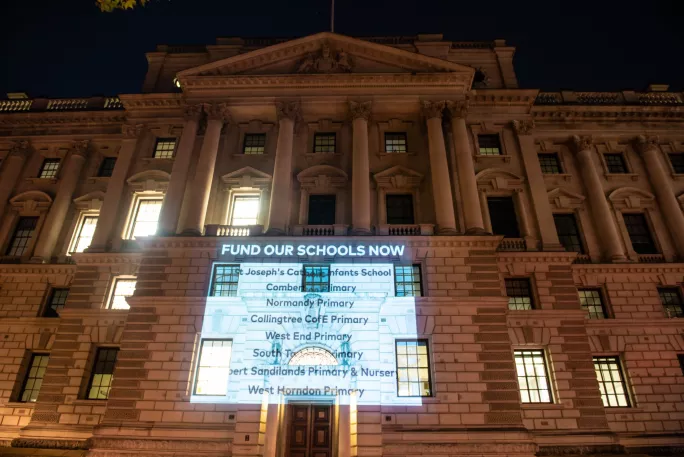 The coalition also projected a list of schools facing cuts on the Treasury