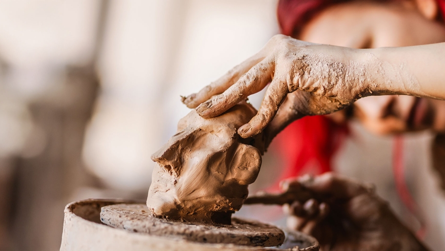 Hand sculpturing a clay figure