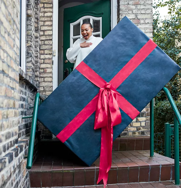 high expectations, behaviour, woman receiving huge parcel