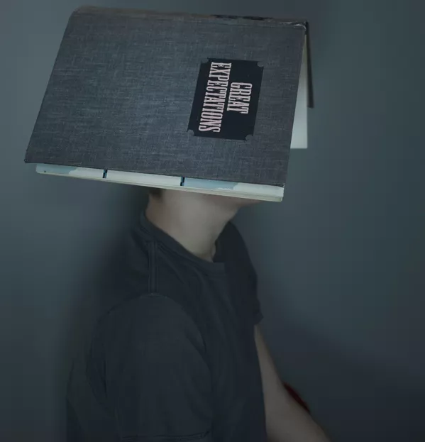 Person With Great Expectations Book Open On Their Head – Secondary Literacy Reading