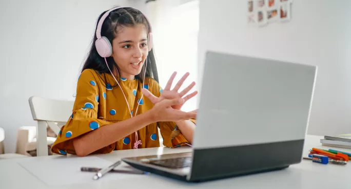 child doing a lesson on their laptop