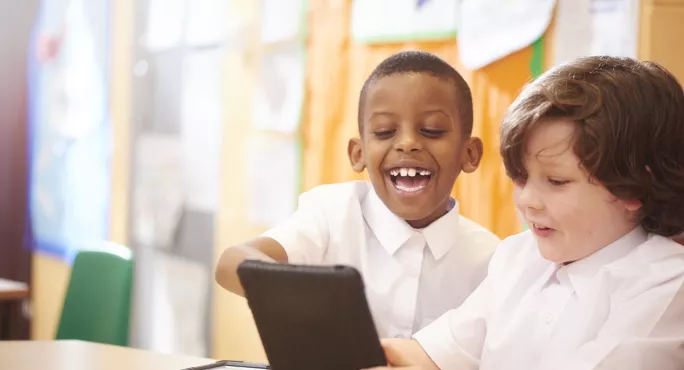 pupils looking at tablet