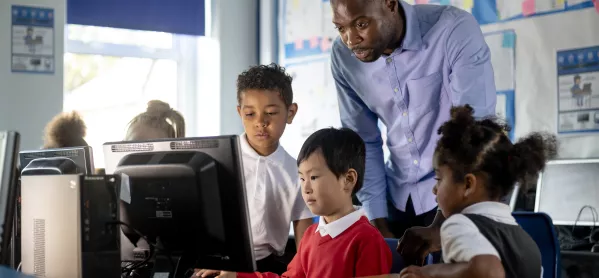 pupils and teacher around a computer