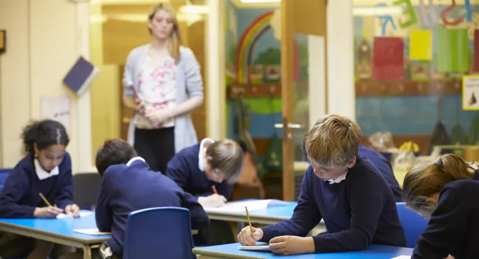 primary pupils working on tests at desks