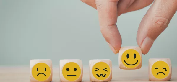 wooden cubes with emotion faces on each