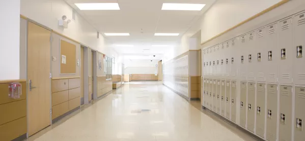 empty corridor with wooden doors and cream lockers