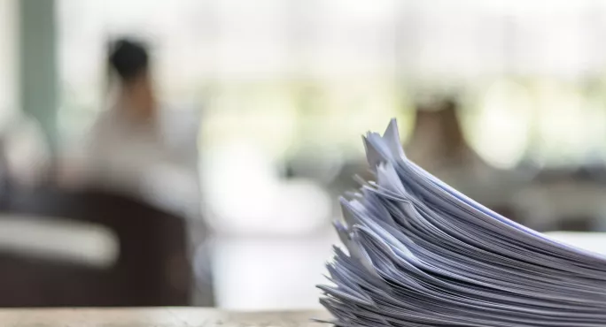 exam papers in forefront with blurred background
