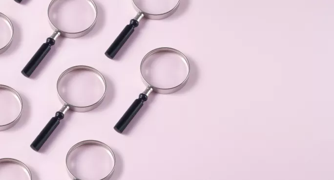 Magnifying Glasses on pink background