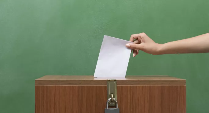 Poll Envelope In Human Hand Inserting To The Ballot Box