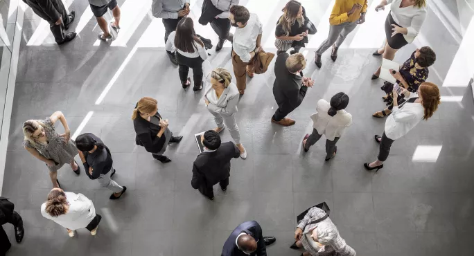 Business People standing round from above 