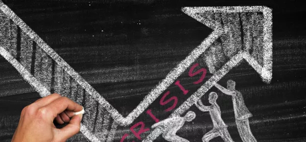 Drawing with chalk on blackboard with arrow and "crisis"