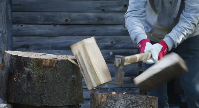 Senior man chopping firewood 