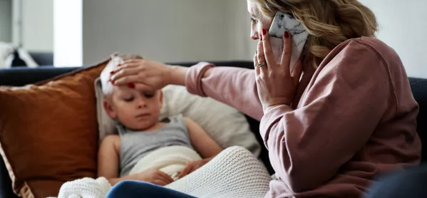 Mother with hand on child's forehead calling her doctor for expert medical advice