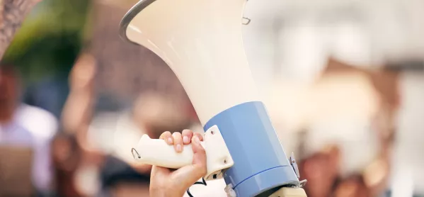 Shot of a protester holding a megaphone during a rally